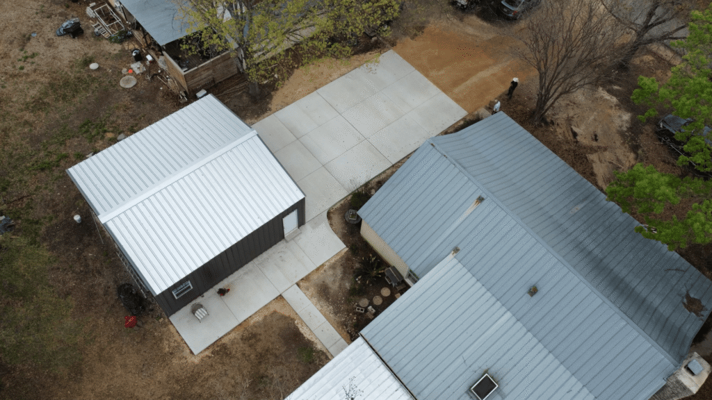 drone-view-of-metal-shop sky view of driveway and metal shop